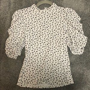 Black & white mock turtleneck with puff sleeve.